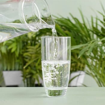 pitcher glass pouring water in a glass cup