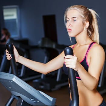 Young girl doing elliptical training