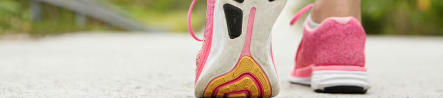 Woman outdoor wearing pink sneakers ready to do a morning walk