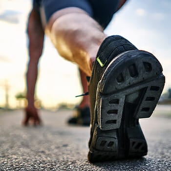 A man in starting position for running