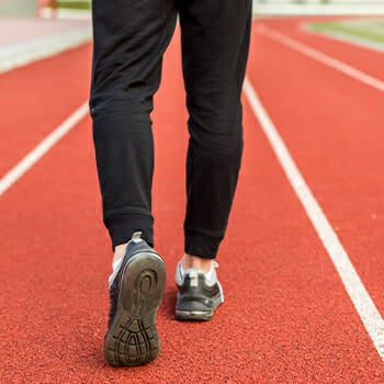 Man walking in red race track