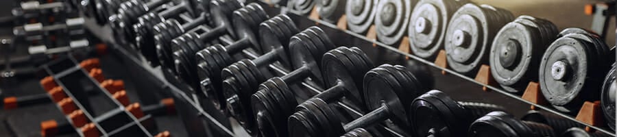 Heavy metal dumb bells on the rack used for weight training