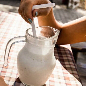 A woman holding her drink in a bottle