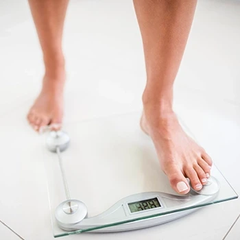 A person using a weighing scale