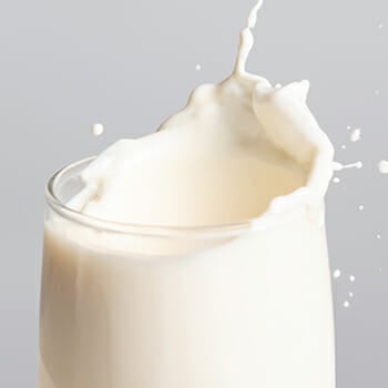 A glass of whole milk dairy splash