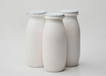 three white plastic bottles of probiotics