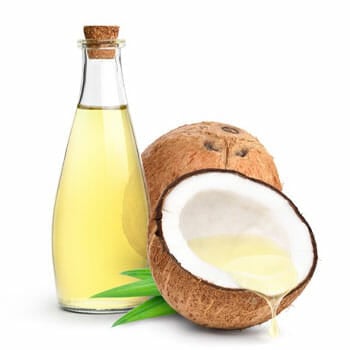 bottle of oil and fresh sliced coconuts