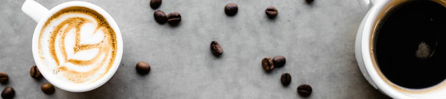 coffee mugs and coffee beans on a gray background