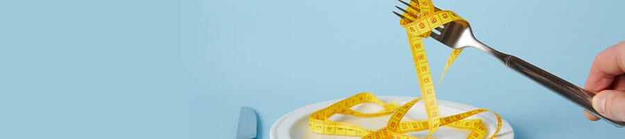 white plate with measuring tape and utensils