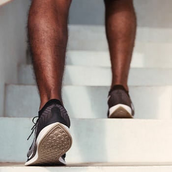 rubber shoes view of a person using a stairs