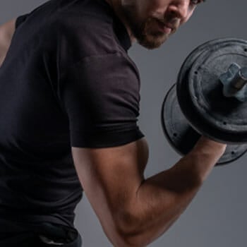 man using a dumbbell for his biceps