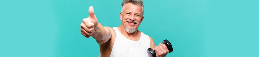 man in a tank top giving a thumbs up while holding a dumbbell