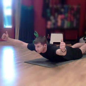 man flat on his stomach on a yoga mat