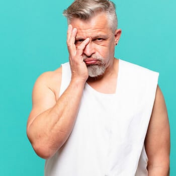 man holding his face in exhaustion