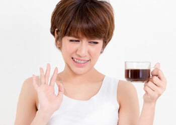 woman avoiding a coffee cup