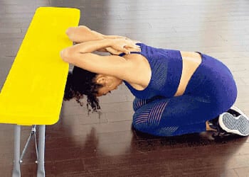 woman in a leaning triceps stretch position