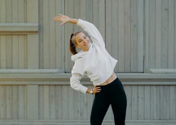 woman in a low impact jumping jack position