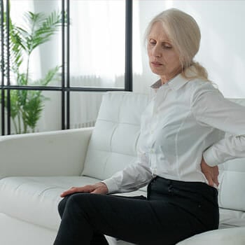 woman seated on the couch tired