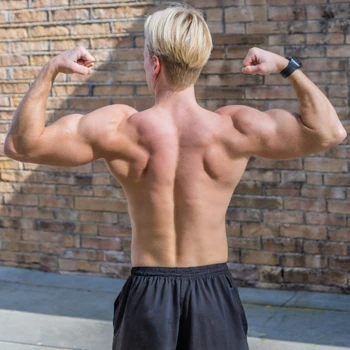 man showing his back while flexing his biceps