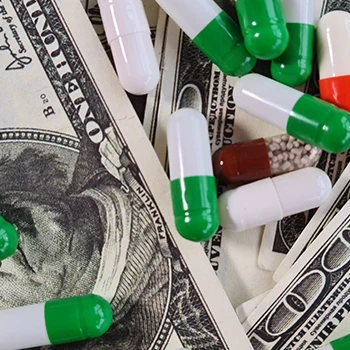 Close up image of pills with dollar bills