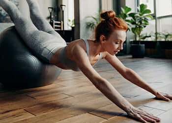 Doing a back hyperextension on an exercise ball