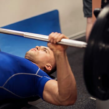 A man doing a bench press exercise