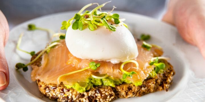 A plate with salmon toast and egg on top