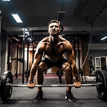 A guy performing a deadlift