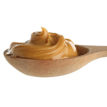 A spoon full of peanut butter