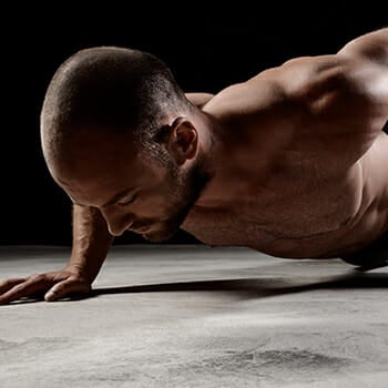 A man doing a one hand push up