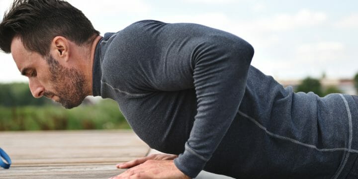 A man doing push-ups outdoors
