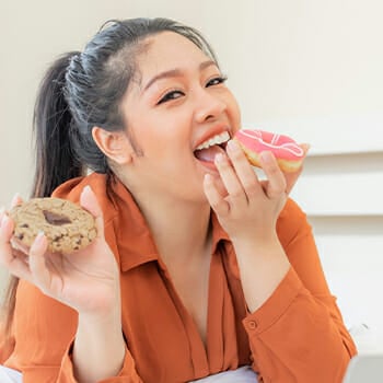 A woman eating donuts