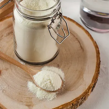 protein powder filling a jar and a spoon
