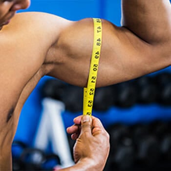 close up image of a man biceps getting measured