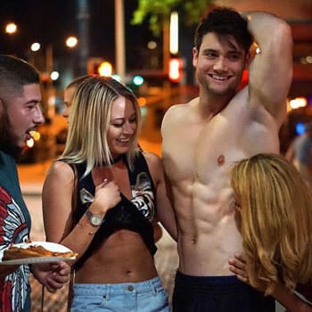 shirtless Connor Murphy in the streets with people looking at him