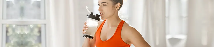 woman about to drink during a workout