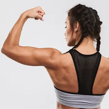 woman showing her back while flexing her arms
