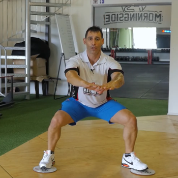 man in a sumo squat position