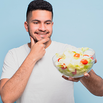 man smiling with his bowl of salad