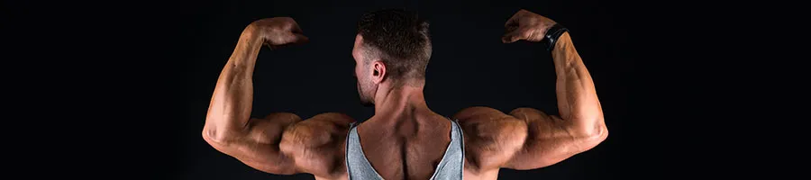 man showing off his arm muscles with back
