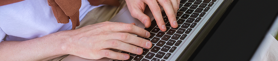 hand view of a person using a laptop