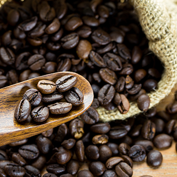 bag and spoonful of coffee beans