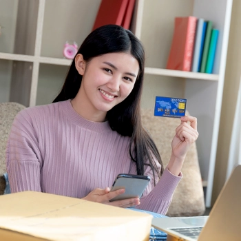 Woman ordering online using her bank card