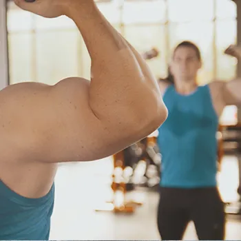 Man flexing his biceps in the mirror