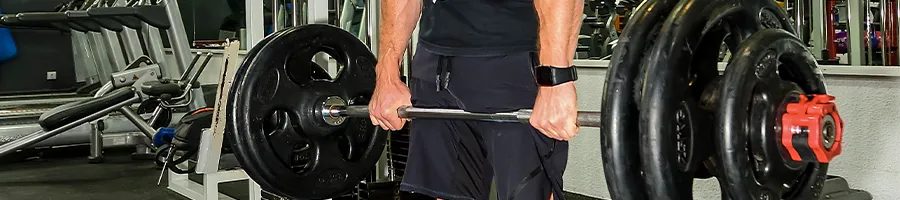 Man holding a barbell to do deadlift workout