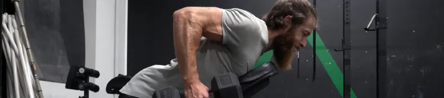 A man building his muscle in a bench