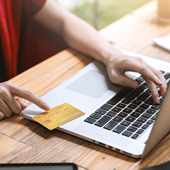 a person entering payment card details on a laptop