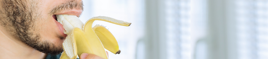 mouth view of a man biting bananas