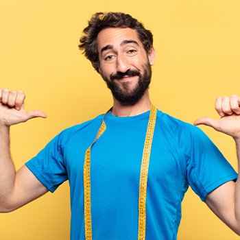 man smiling with his arms up