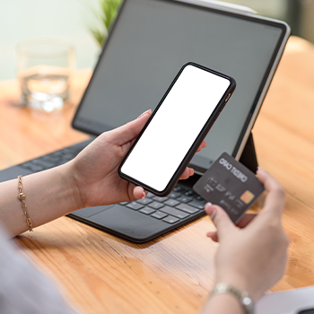 hand view of a person using his phone and credit card